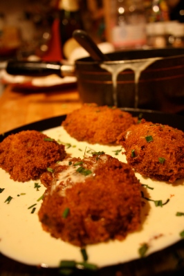 Homemade Canederli (tradional bread balls) stuffed with Emmenthal cheese, Fontina cheese and coated in Parmesan cheese cream.